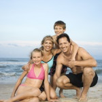 Smiling happy family on beach.